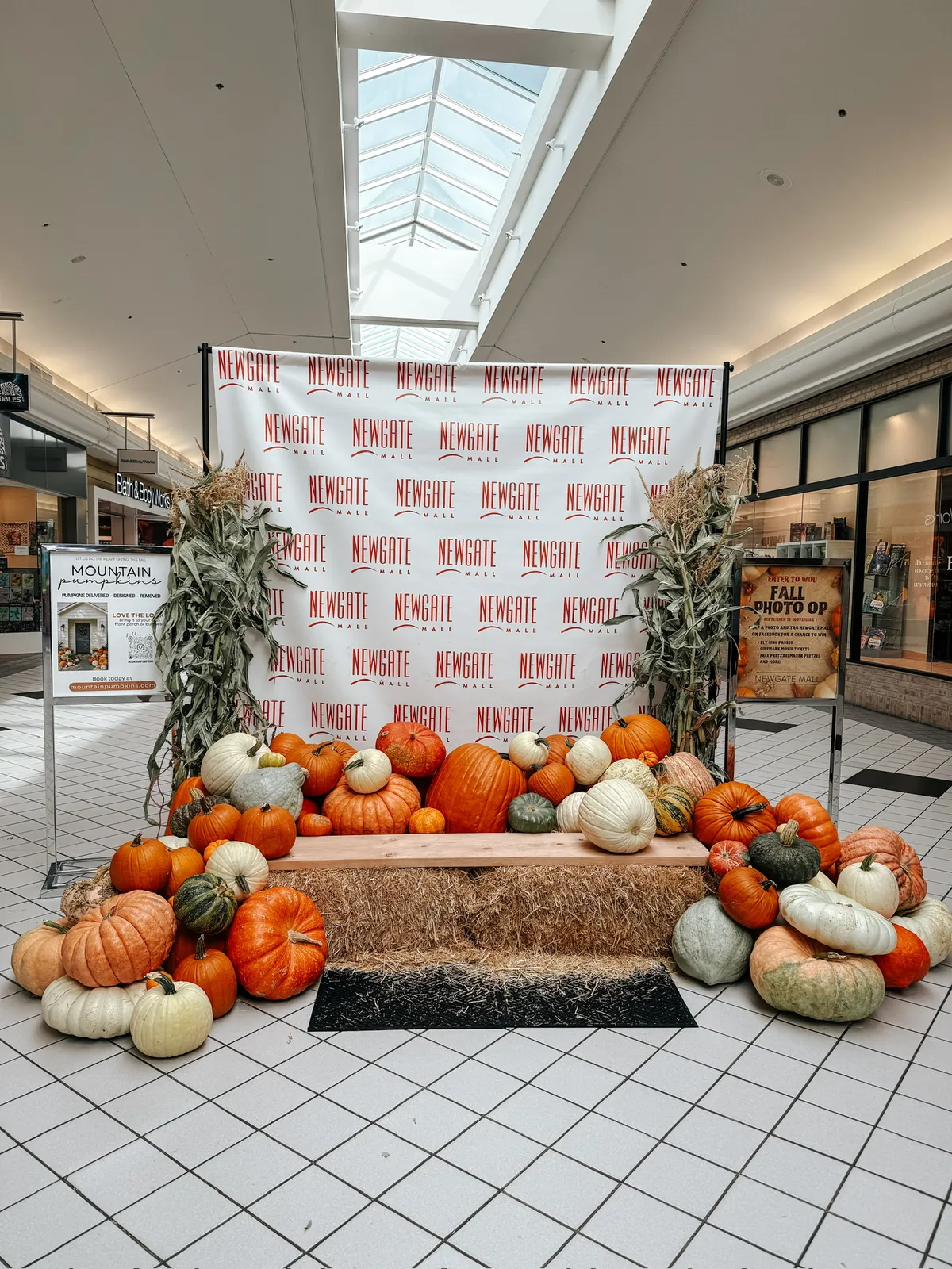 Indoor mall pumpkin photo-op display shown from the concourse walkway
